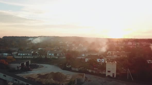 air above the city is filled with smoke after a fire from drought on the background of sunset. alt
