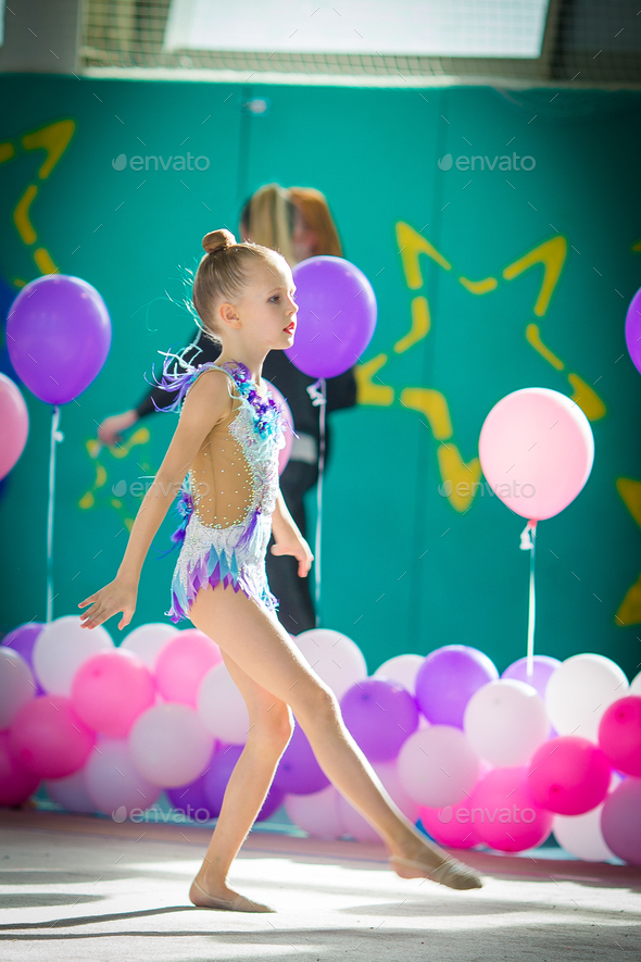 Adorable gymnast participates in competitions in rhythmic gymnastics ...