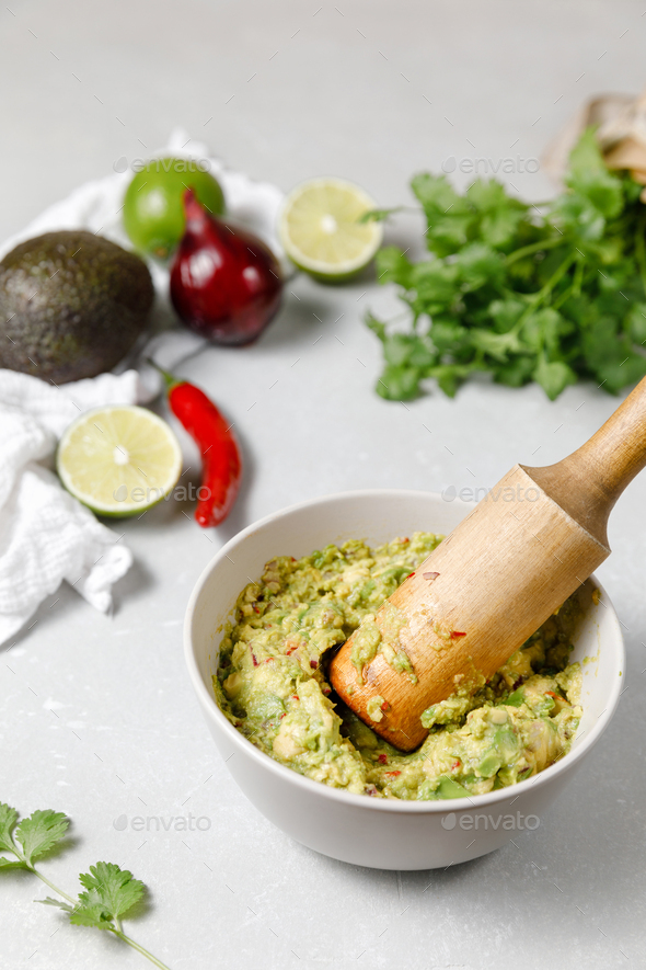 Guacamole cooking background. Ingredients for Mexican Sauce. Avocado dip in a mortar Stock Photo