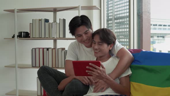 Male lgbt couple sitting on the sofa loving each other, concept lgbt