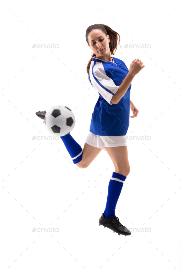 Full length of caucasian young female player kicking soccer ball with back heel while playing soccer