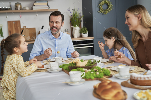 Caucasian family of four eating an easter dinner at home Stock Photo by ...