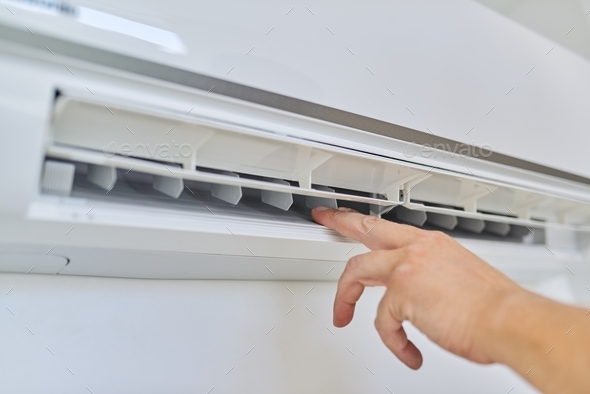Installing an air conditioner in an apartment office, close-up of an engineer hand