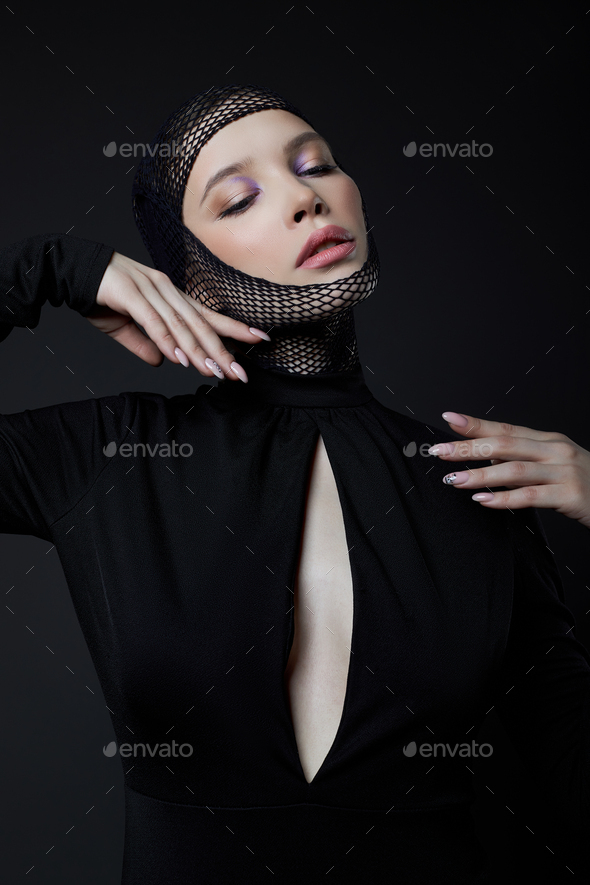 Woman with nylon stocking mesh on head. Black mesh bandage on face woman in black dress with a low