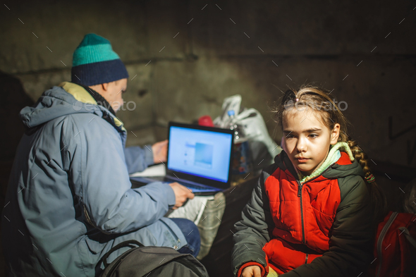 Ukrainian girl and journalist sit in bomb shelter