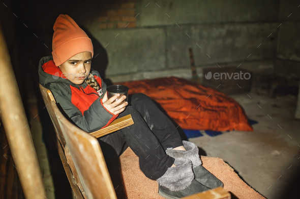 Ukrainian girl sits in bomb shelter, drinks tea and waits for end of airstrikes