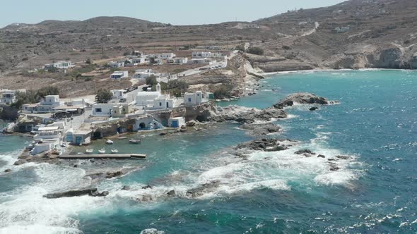 Wide Establishing Shot of Greek Fishing Village Build Right By the Ocean alt