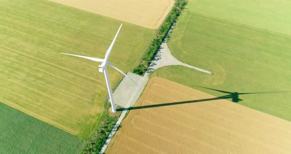 Windmill for electric power production in the agricultural fields. View from above. alt