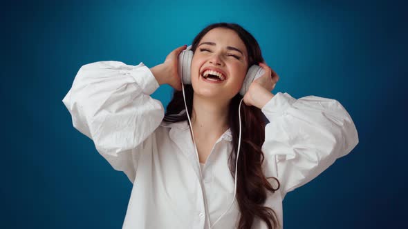 Joyful Attractive Woman Listening to Music with Headphones and Moving to the Beat alt