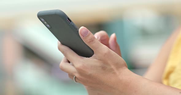 Woman use of mobile phone inside shopping mall alt