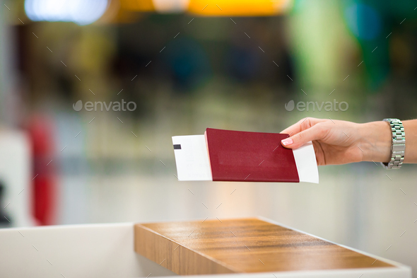 Closeup passports and boarding pass at airport indoor - Stock Photo - Images