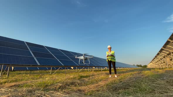 Technician and Investor Using Infrared Drone Technology to Inspect Solar Panels and Wind Turbines in