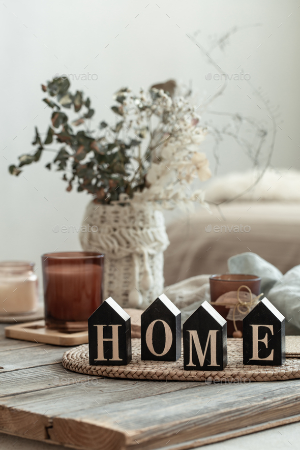 Close up decorative word home on blurred background with candles. Stock  Photo by puhimec