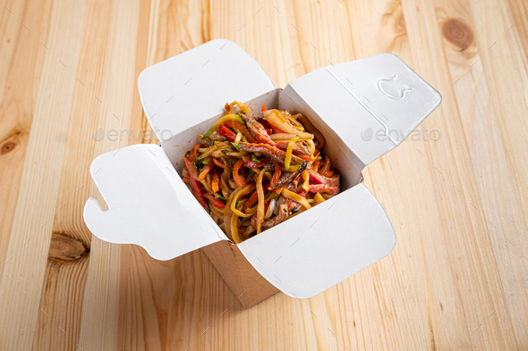 Udon noodles with veal, cucumber, cabbage and bell pepper in take away box