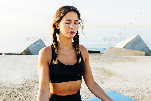 Adult woman doing yoga. Beautiful woman sitting in meditation yoga