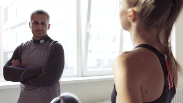 Beautiful Woman Boxing Combat Bag with Sport Trainer Together alt