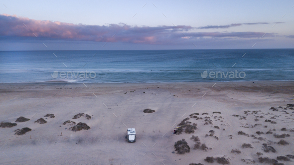 Camper van in outdoors alone camp site enjoy freedom and sunset with ocean and sky view