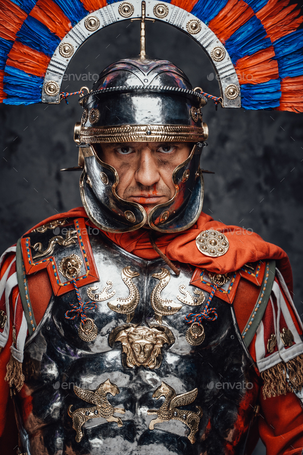 Studio shot of fearful roman soldier with colorful plumed helmet - Stock Photo - Images