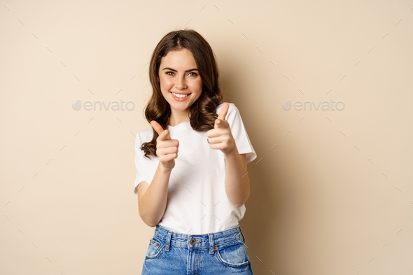 You got this, congrats. Smiling young woman pointing fingers at camera, cheering, complimenting