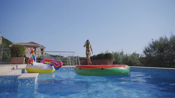 Woman with Inflatable Pool Toys Relax in Swimming Pool alt