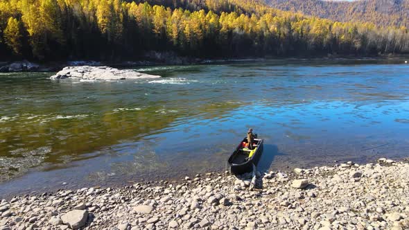 Fisherman Fishing on the Bank of a Beautiful River Boat Mountain Autumn alt