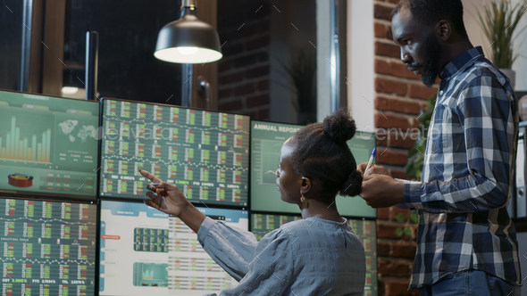 Man and woman doing teamwork to develop hedge fund trade - Stock Photo - Images