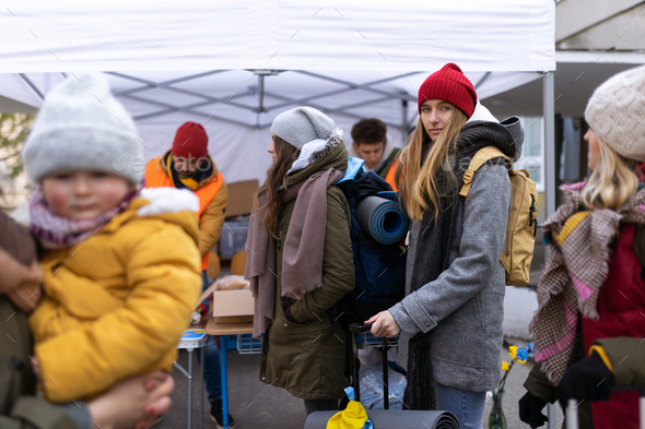 Ukrainian immigrants crossing border and getting donations from volunteers, Ukrainian war concept - Stock Photo - Images
