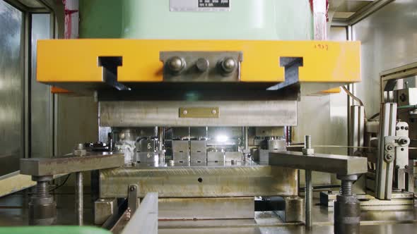 A large industrial punch press forming sheet metal parts alt