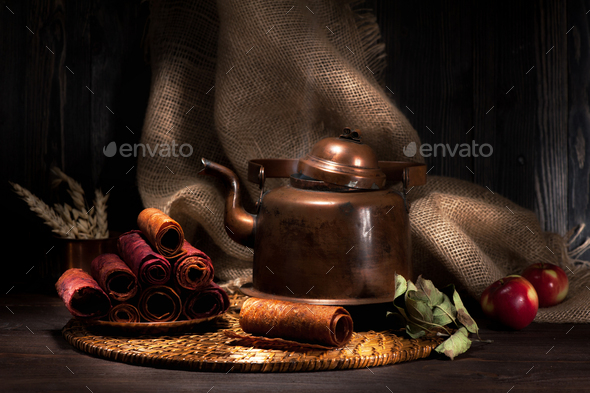 still life sweet dried apples and vintage copper kettle with tea. rustic style - Stock Photo - Images