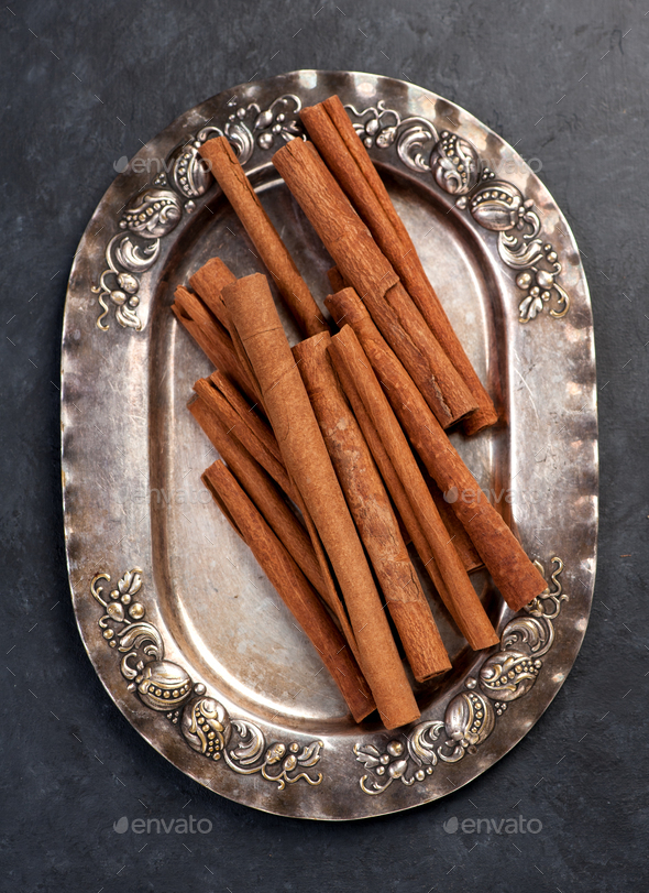 Cinnamon sticks on vintage plate - Stock Photo - Images