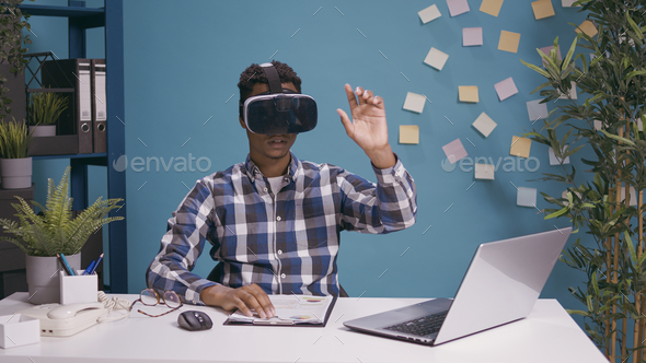 Cheerful man using virtual reality glasses with interactive vision