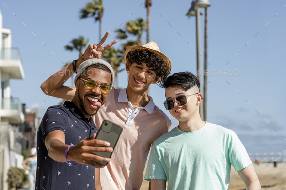 Teen boys taking selfie, enjoying summer together outdoors in