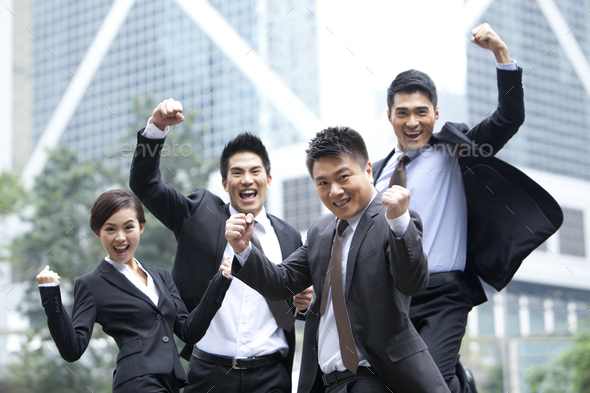Excited business persons punching the air and celebrating, Hong Kong