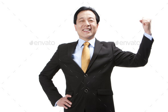 Excited senior businessman punching the air