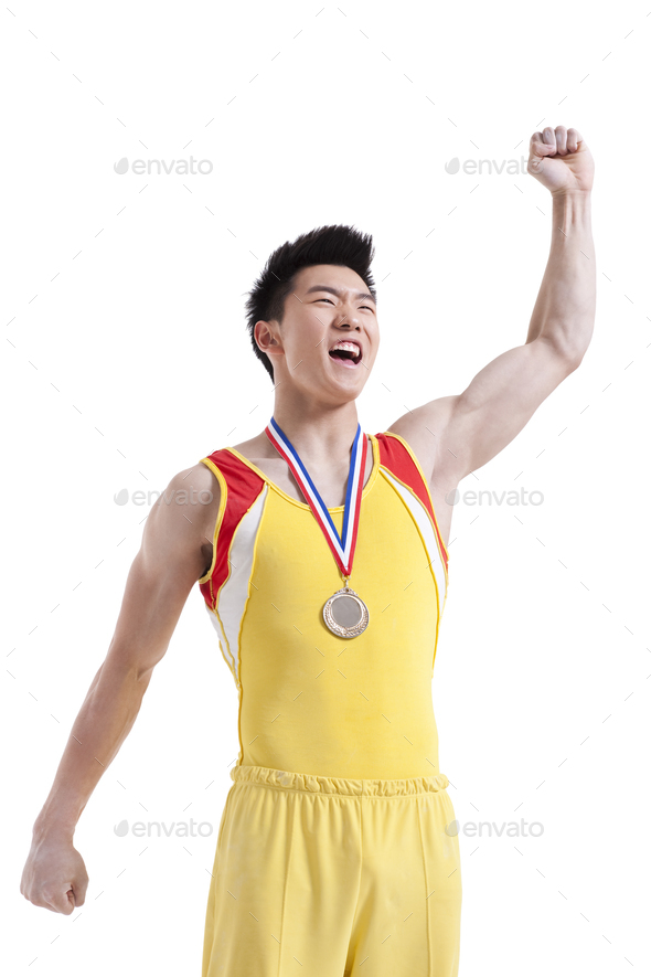 Athlete with a medal punching the air for winning