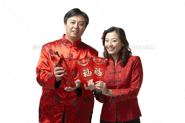 A couple holds gifts and a bottle of wine for Chinese New Year
