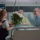 Little Girl Running to Hug and Give Flowers to Aged Patient in Hospital Ward Bed - VideoHive Item for Sale