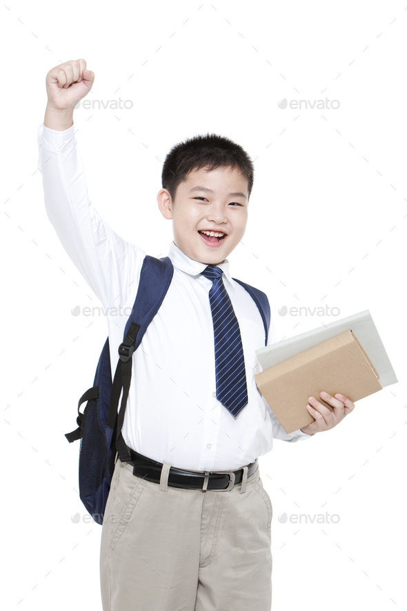 Cheerful schoolboy punching the air with books