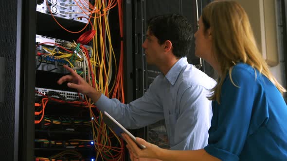 Technician looking at open server locker alt