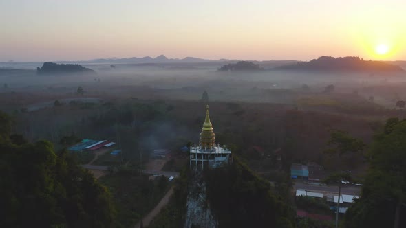 Aerial view of Khao Na Nai pagoda stupa. Luang Dharma Temple Park with green mountain hills alt