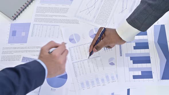 Close Up of Hands of Business Team Working on Documents alt