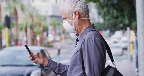 Caucasian man out and about in the street wearing on a face mask against coronavirus alt
