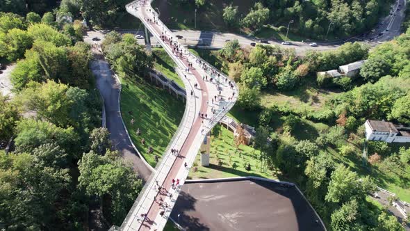 Aerial Top View of Pedestrian Glass Bridge with a Crowd of Walking People alt