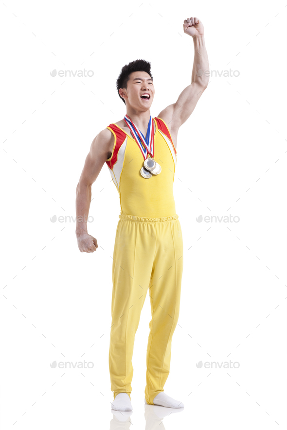 Athlete with medals punching the air for winning