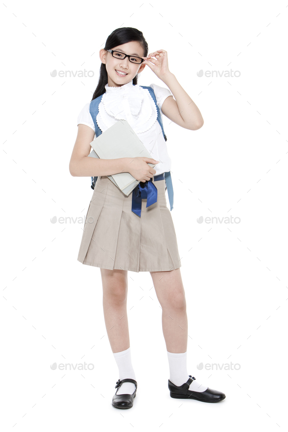 Pretty Schoolgirl Adjusting Her Glasses With Books And Schoolbag Stock