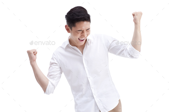 Cheerful young man punching the air