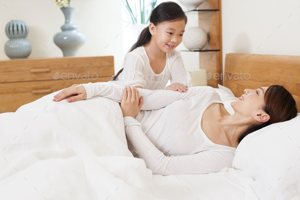 Little Girl Waking Up Her Mother Stock Photo By Bluejeanimages 