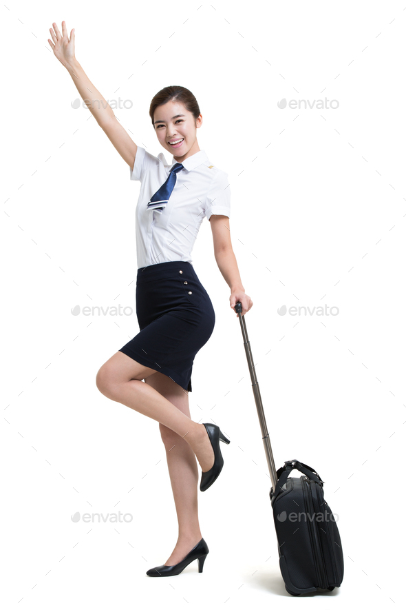 Smiling airline stewardess with wheeled luggage greeting