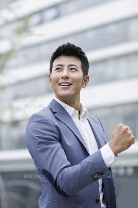 Happy businessman punching the air