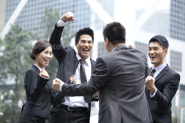 Excited business persons punching the air and celebrating, Hong Kong